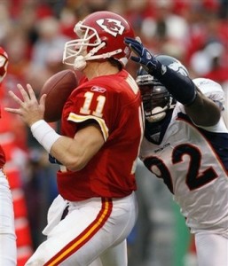 Damon Huard gets sacked by Elvis Dumervil (AP Photo)