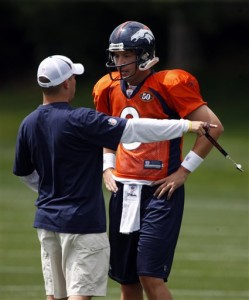 Denver Broncos head coach Josh McDaniels, left, directs quarterback Kyle Orton during passing drills at a preliminary session before the start of the team's training camp for the upcoming NFL season in Englewood, Colo., on Wednesday, July 29, 2009. (AP Photo/David Zalubowski)