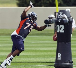 Denver Broncos rookie defensive lineman Chris Baker attacks a dummy during drills at the NFL football team's training camp in Englewood, Colo., on Monday, July 27, 2009. (AP Photo/Ed Andrieski)
