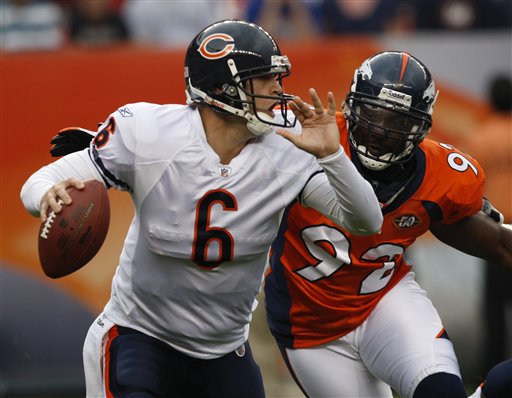 Chicago Bears quarterback Jay Cutler (6) scrambles out of the pocket to avoid the rush of Denver Broncos' Elvis Dumervil (92) during the first quarter of an NFL preseason football game in Denver on Sunday, Aug. 30, 2009. (AP Photo/Ed Andrieski )