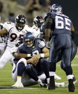 Seattle Seahawks quarterback Matt Hasselbeck is sacked by Denver Broncos' Kenny Peterson in the first half of an NFL preseason football game, Saturday, Aug. 22, 2009, in Seattle. (AP Photo/Ted S. Warren)