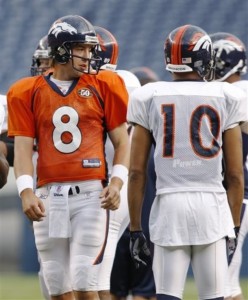 Denver Broncos quarterback Kyle Orton, left, talks with wide receiver Jabar Gaffney as they take part in drills during a scrimmage as part of NFL football training camp at Invesco Field at Mile High in Denver on Thursday, Aug. 6, 2009. (AP Photo/David Zalubowski)