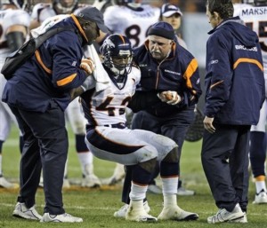 Former Denver Broncos running back Ryan Torain (42) is helped off the field after spraining his knee in the second quarter of an NFL football game against the Cleveland Browns Thursday, Nov. 6, 2008, in Cleveland. (AP Photo/Ron Schwane)