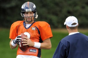 Kyle Orton, seen here chatting with Josh McDaniels, is wearing a protective glove over his right hand during practice. (John Leyba/Denver Post)