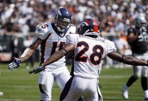 Denver Broncos wide receiver Brandon Marshall (15) is congratulated by running back Correll Buckhalter (28) after scoring past the Oakland Raiders on a two yard pass from quarterback Kyle Orton in the first quarter of an NFL football game in Oakland, Calif., Sunday, Sept. 27, 2009. (AP Photo/Ben Margot)