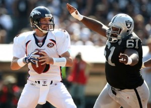 Kyle Orton #8 of the Denver Broncos is rushed by Gerard Warren #61 of the Oakland Raiders on September 27, 2009 during an NFL game at the Oakland-Alameda County Coliseum in Oakland, California.  (Jed Jacobsohn/Getty Images)
