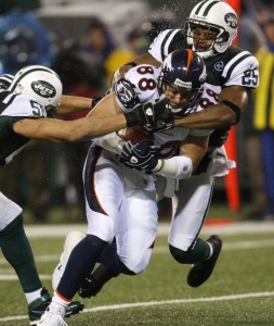 Denver Broncos Tony Scheffler (88) is tackled by New York Jets safety Kerry Rhodes (R) in 2008.  (REUTERS/Mike Segar)