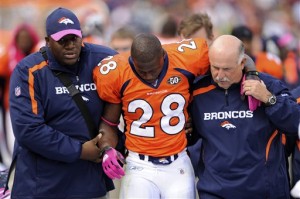 Denver Broncos running back Correll Buckhalter is helped off of the field by trainers after he was injured during the third quarter of an NFL football game against the Dallas Cowboys on Sunday, Oct. 4, 2009, in Denver.  (AP Photo/ Chris Schneider)