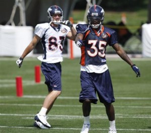 D.J. Johnson loosens up with fellow rookie Nate Swift prior to practice at the team's training facility in Englewood, Co - Wednesday July 29, 2009