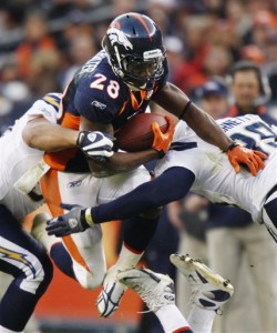 Denver Broncos' Correll Buckhalter (28) is stopped in midair by San Diego Chargers' Kevin Burnett, right, and Ian Scott during the third quarter of an NFL football game, Sunday, Nov. 22, 2009, in Denver. (AP Photo/Jack Dempsey)