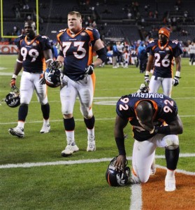 Denver Broncos' Elvis Dumervil (92) kneels on the ground after the Broncos lost to the San Diego Chargers in their NFL football game, Sunday, Nov. 22, 2009, in Denver. The Chargers defeated the Broncos 32-3. (AP Photo/Chris Schneider)
