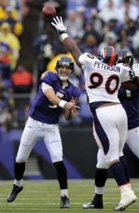 Denver Broncos defensive end Kenny Peterson, right, stretches to block Baltimore Ravens quarterback Joe Flacco's pass during the first quarter of an NFL football game, Sunday, Nov. 1, 2009, in Baltimore. (AP Photo/Nick Wass)
