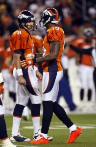 Denver Broncos wide receiver Brandon Marshall (R) wearing fluorescent orange shoes, talks to quarterback Kyle Orton in the first quarter against the Pittsburgh Steelers of their NFL football game in Denver November 9, 2009.  (REUTERS/Rick Wilking)