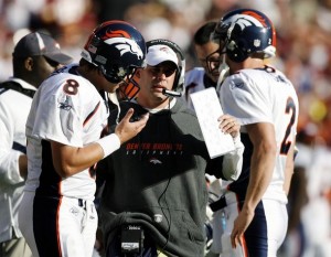 Denver Broncos head coach Josh McDaniels (C) talks to his starting quarterback Kyle Orton (L) and back up quarterback Chris Simms (R) in the first half of their NFL football game against the Washington Redskins in Landover, Maryland November 15, 2009. Orton did not play in the second half of the game, which the Redskins' won in an upset victory over Denver. (REUTERS/Gary Cameron)