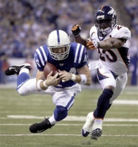 Indianapolis Colts tight end Dallas Clark, left, pulls in a pass in front of Denver Broncos safety Brian Dawkins (20) in the second quarter of an NFL football game in Indianapolis, Sunday, Dec. 13, 2009. (AP Photo/AJ Mast)