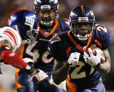 Denver Broncos running back Knowshon Moreno, right, runs before a tackle by New York Giants safety Michael Johnson, left, during the first quarter of an NFL football game in Denver, Thursday, Nov. 26, 2009. (AP Photo/Jack Dempsey)