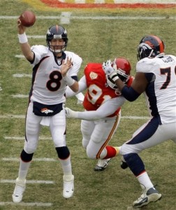 Denver Broncos quarterback Kyle Orton (8) passes while offensive tackle Ryan Clady, right, blocks Kansas City Chiefs defensive end Tamba Hali (91) during the first quarter of an NFL football game Sunday, Dec. 6, 2009 in Kansas City, Mo. (AP Photo/Charlie Riedel)