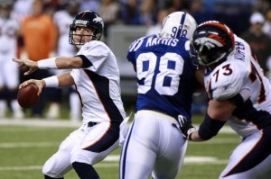 Denver Broncos quarterback Kyle Orton (L) attempts a pass while Broncos offensive guard Chris Kuper (73) blocks Indianapolis Colts defensive end Robert Mathis during their NFL game in Indianapolis December 13, 2009.  (REUTERS photo/Brent Smith)