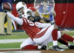 Arizona Cardinals  linebacker Karlos Dansby (R) celebrates with teammate Calais Campbell (L) after Dansby returned a fumble by Green Bay Packer's quarterback Aaron Rodgers for a touchdown in overtime to defeat the Green Bay Packers.  (REUTERS/Rick Scuteri