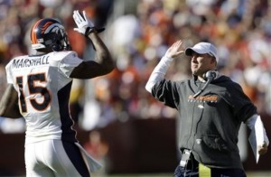Denver Broncos' Brandon Marshall (15) celebrates with head coach Josh McDaniels after scoring a touchdown against the Washington Redskins during the first half of an NFL football game, Sunday, Nov. 15, 2009, in Landover, Md. (AP Photo/Rob Carr)