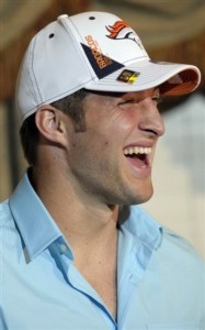 Denver Broncos first-round draft pick Tim Tebow laughs while answering a question during an after-draft news conference. (AP Photo/Phelan M. Ebenhack)