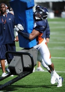 Jarvis Moss hits the sled during the morning session at Broncos training camp. (AP Photo/Jack Dempsey)