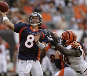 Kyle Orton is pressured by Bengals defensive end Antwan Odom in the first quarter. (AP Photo/Al Behrman) 