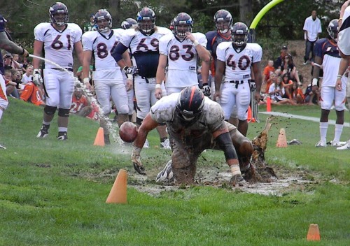 Denver Broncos rookie offensive lineman Jeff Stehle gets drenched in mud during a rookie hazing loose ball drill Thursday (BroncoTalk.net)