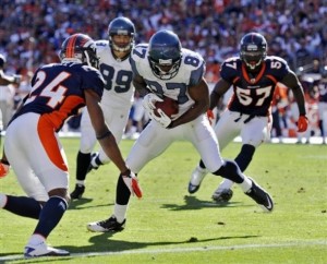 Seattle Seahawks wide receiver Ben Obomanu (87) eyes the end zone after pulling in a 12-yard pass on a touchdown during the second half of an NFL football game against the Denver Broncos Sunday, Sept. 19, 2010, in Denver. Denver's Champ Bailey (24) and Mario Haggan defend on the play.  (AP Photo/Jack Dempsey)