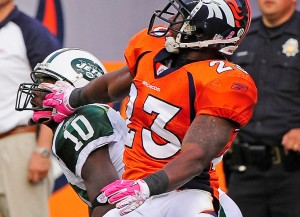 Denver Broncos defender Renaldo Hill is called for pass interference pulling on the face mask of New York Jets' wide receiver Santonio Holmes during the fourth quarter of play Sunday October 17, 2010 at Invesco Field at Mile High. Photo by Joe Amon, The Denver Post