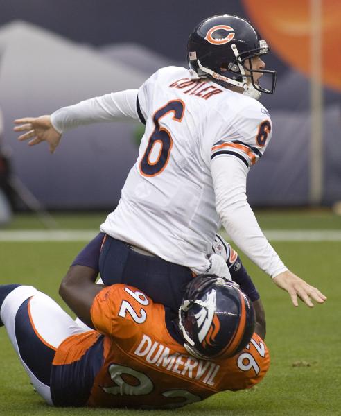 Chicago Bears quarterback Jay Cutler watches his pass as Denver Broncos linebacker Elvis Dumervil takes him down during the first quarter at Invesco Field at Mile High in Denver on August 30, 2009. Denver meets Chicago for the first time since trading away quarterback Jay Cutler. UPI/Gary C. Caskey