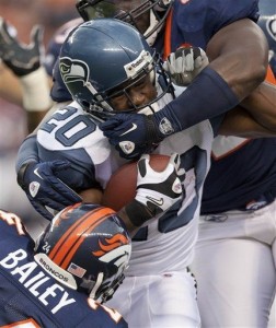 Seattle Seahawks running back Justin Forsett (20) is tackled by Denver Broncos defensive end Elvis Dumervil (92) and Broncos cornerback Champ Bailey (24) in the first quarter of a presason NFL football game, Saturday, Aug. 27, 2011, in Denver. (AP Photo/Julie Jacobson)