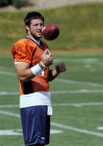 Denver Broncos quarterback Tim Tebow tosses the ball during training camp in Englewood, Colo., on Friday, Aug. 19, 2011.(AP Photo/Jack Dempsey)
