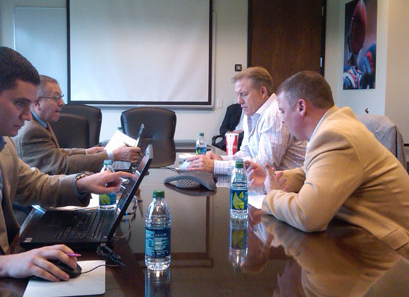 Broncos' VP John Elway (far right) and GM Brian Xanders (near right) hold a conference call with fans in April with team PR Executives Jim Saccomano (far left) and Patrick Smyth (near left) present.  (Image courtesy of Gray Caldwell/Denver Broncos)