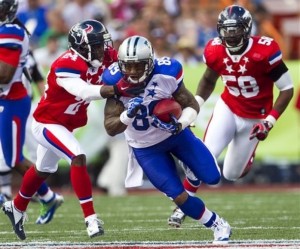 Carolina Panthers wide receiver Steve Smith (89), of the NFC, gets pulled down by Houston Texans cornerback Johnathan Joseph (24) as Denver Broncos outside linebacker Von Miller (58) gives chase during the third quarter of the NFL Pro Bowl football game, Sunday, Jan. 29, 2012, in Honolulu. (AP Photo/Marco Garcia)