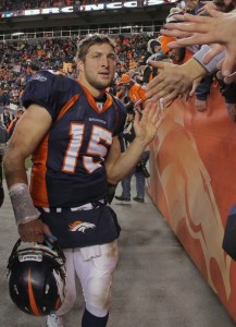 Quarterback Tim Tebow #15 of the Denver Broncos high fives the fans after defeating the Pittsburgh Steelers at Sports Authority Field at Mile High on January 8, 2012 in Denver, Colorado. The Broncos defeated the Steelers 29-23 in overtime of their AFC Wild Card Playoff game.  (Doug Pensinger/Getty Images)