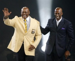 Floyd Little and his presenter, son Marc Little, are introduced at the Pro Football Hall of Fame.  (AP Photo/Scott Heckel)