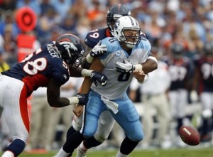 Tennessee Titans quarterback Matt Hasselbeck (8) fumbles the ball as he is hit by Denver Broncos defenders Von Miller (58) and  Kevin Vickerson (99) in the third quarter of an NFL football game on Sunday, Sept. 25, 2011, in Nashville, Tenn. The Broncos recovered the ball but the Titans won 17-14. (AP Photo/Wade Payne)
