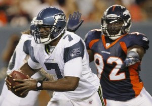 Denver Broncos defensive end Elvis Dumervil chases Seattle Seahawks quarterback Tavaris Jackson before Jackson was sacked in Denver