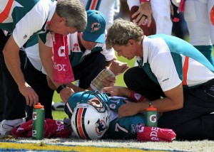 Miami Dolphins quarterback Chad Henne (7) lays on the ground after being injured in the first half against the San Diego Chargers during their NFL football game in San Diego, California October 2, 2011.   REUTERS/Mike Blake