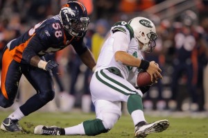 Mark Sanchez #6 of the New York Jets recovers a fumbled snap in the second quarter against Von Miller #58 of the Denver Broncos at Invesco Field at Mile High on November 17, 2011 in Denver, Colorado.  (Photo by Doug Pensinger/Getty Imag