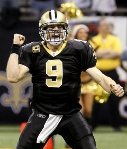 New Orleans Saints quarterback Drew Brees celebrates a touchdown by running back Pierre Thomas in the first quarter of an NFL football game against the Atlanta Falcons in New Orleans, Monday, Dec. 26, 2011. (AP Photo/Bill Haber)