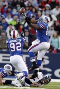 Buffalo Bills' Spencer Johnson (91) intercepts a pass by Denver Broncos' Tim Tebow (15) during the fourth quarter of an NFL football game in Orchard Park, N.Y., Saturday, Dec. 24, 2011. Johnson scored a touchdown on the play. The Bills won 40-14. (AP Photo/David Duprey)