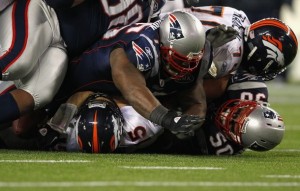 Vince Wilfork #75 and Rob Ninkovich #50 of the New England Patriots sack Tim Tebow #15 of the Denver Broncos during their AFC Divisional Playoff Game at Gillette Stadium on January 14, 2012 in Foxboro, Massachusetts. (Al Bello/Getty Images)