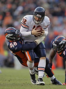 Quarterback Caleb Hanie #12 of the Chicago Bears is sacked by linebacker Von Miller #58 of the Denver Broncos at Sports Authority Field at Mile High on December 11, 2011 in Denver, Colorado. The Brocnos defeated the Bears 13-10 in overtime.  (Photo by Doug Pensinger/Getty Images)