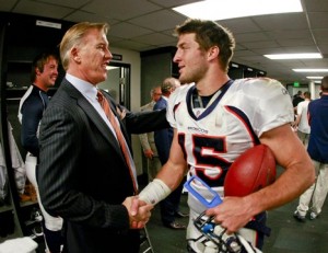 John Elway and Tim Tebow.  (Getty Images)