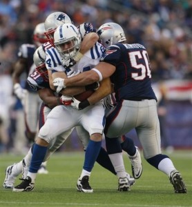 Indianapolis Colts tight end Jacob Tamme (84) is sandwiched between New England Patriots outside linebacker Rob Ninkovich (50) and another Patriot during the first half of an NFL football game in Foxborough, Mass., Sunday, Dec. 4, 2011. The Patriots defeated the Colts 31-24. (AP Photo/Elise Amendola)