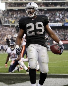 Michael Bush celebrates after scoring on a 3-yard run against the Chicago Bears during the fourth quarter of an NFL football game in Oakland, Calif., Sunday, Nov. 27, 2011. (AP Photo/Paul Sakuma)