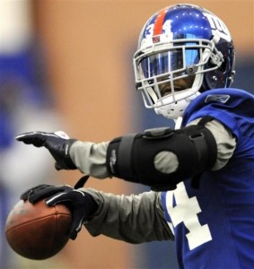 New York Giants safety Deon Grant looks to throw a pass during NFL football practice Friday, Jan. 27, 2012, in East Rutherford, N.J. The Giants are scheduled to face the New England Patriots in Super Bowl XLVI on Feb. 5 in Indianapolis. (AP Photo/Bill Kostroun)